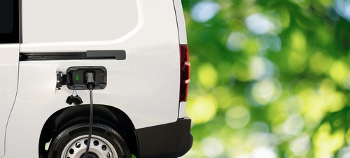 Electric,Delivery,Van,On,A,Green,Background