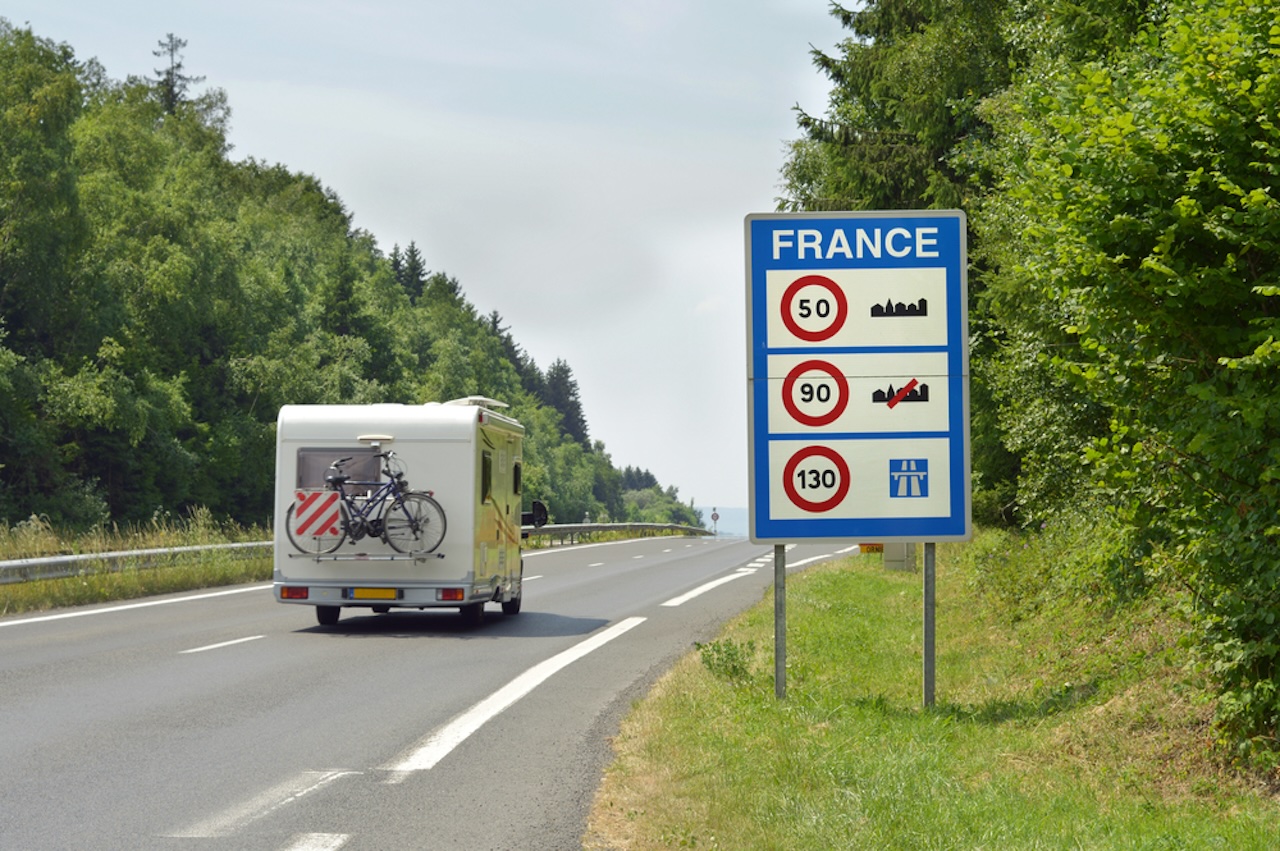 Camper,Passing,The,Sign,Of,Speed,Limits,At,The,French